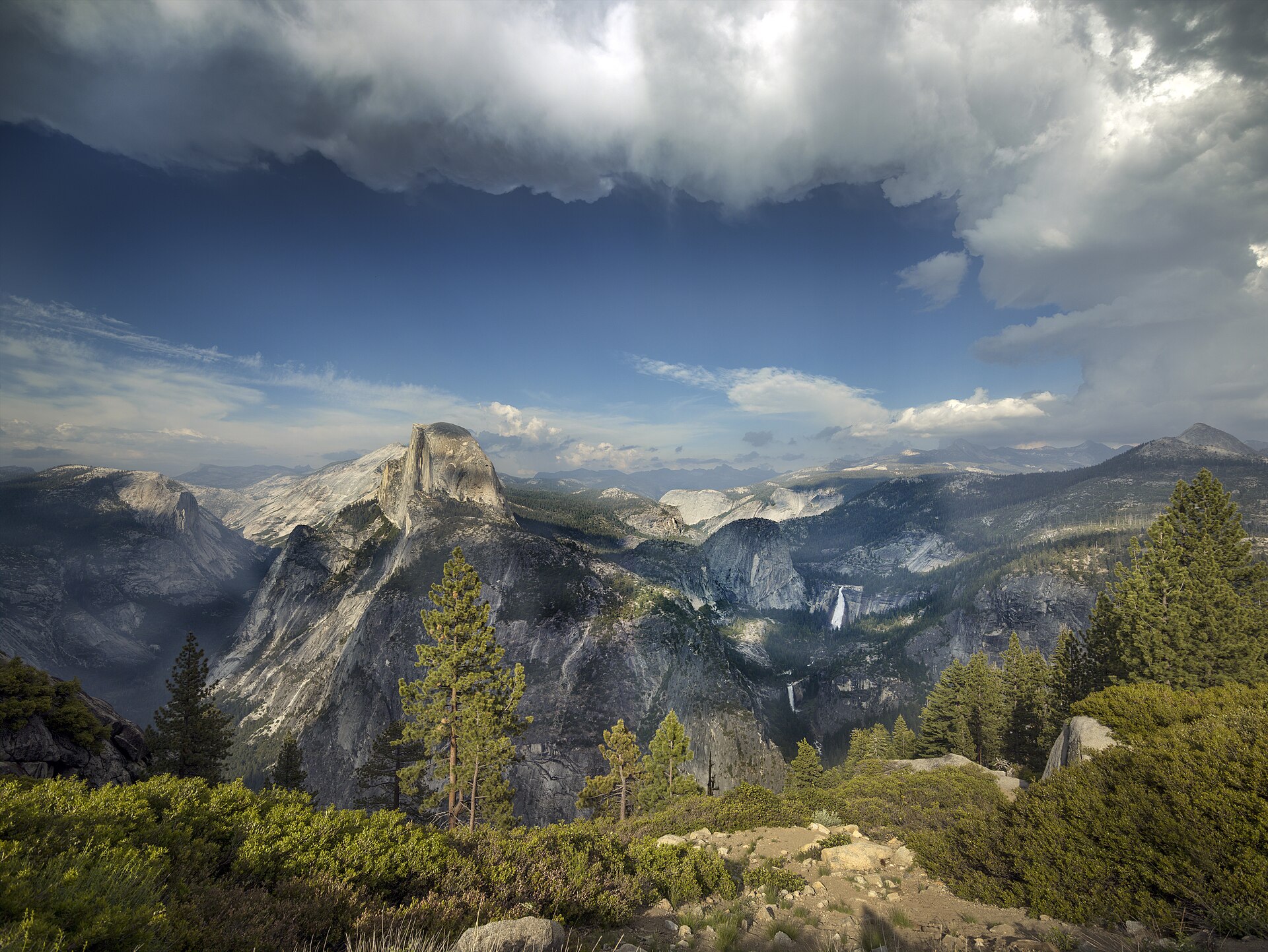 Half Dome rising above the Yosemite high country under a dramatic sky
